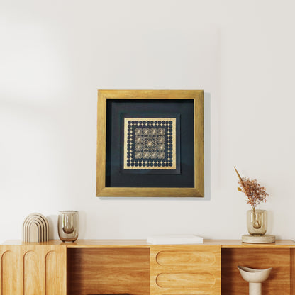 Framed artwork on a wall above a wooden console table with decorative items.