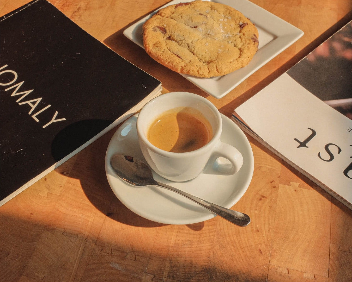 Cup of coffee with a cookie on a wooden table